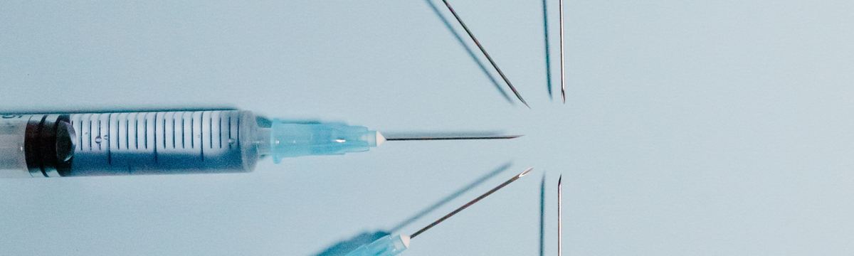 Disposable syringes arranged in a circle on a pale blue background